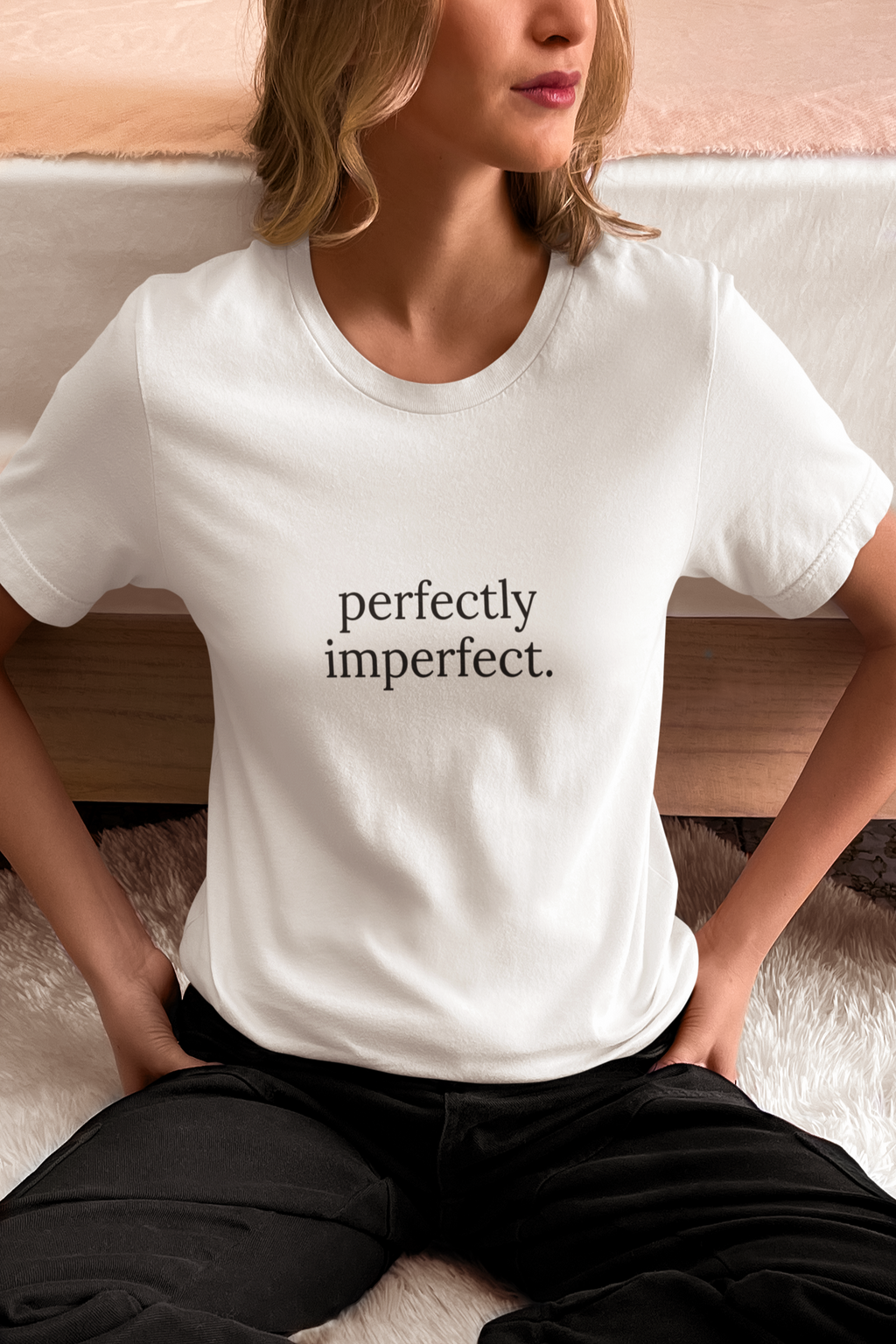 Person wearing a white t-shirt with a provocative message in yellow text.