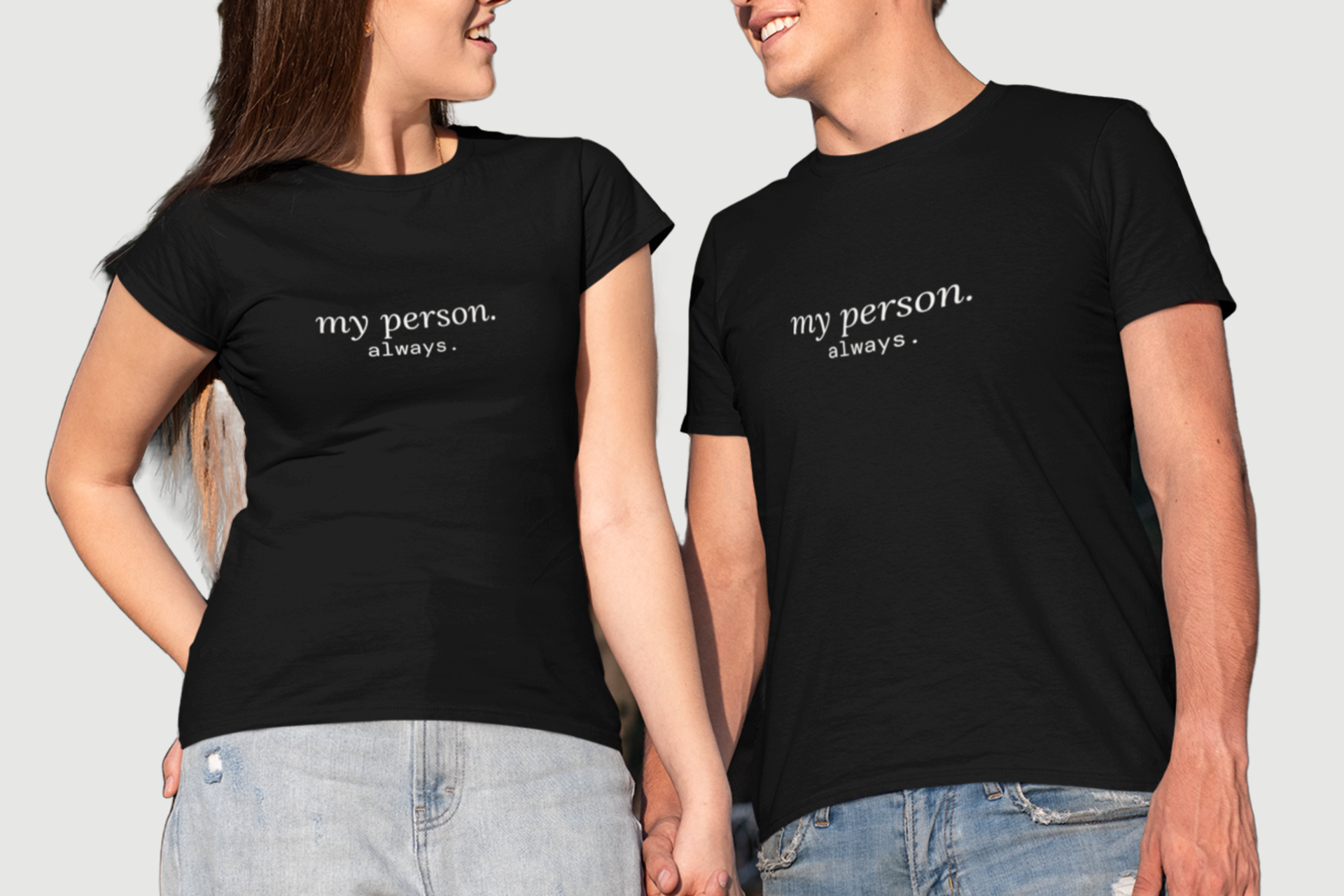 A man and a woman wearing matching black short-sleeve t-shirts with the white printed text 'my person. always.