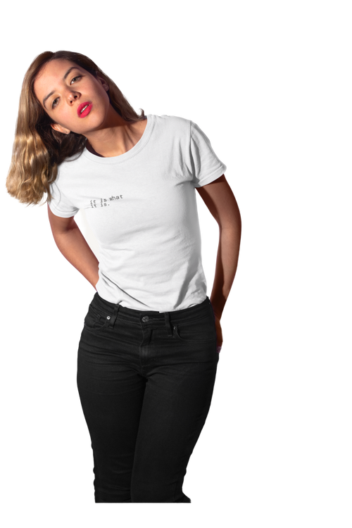 A woman posing in a white crewneck t-shirt with a small black graphic on the left chest, paired with black jeans, against a solid white background.