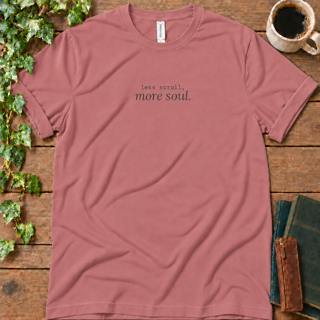 Mauve regular-fit tee printed with less scroll, more soul., flat lay on rustic wood with ivy, coffee and vintage books