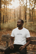less scroll more soul. white tee, man in autumn forest