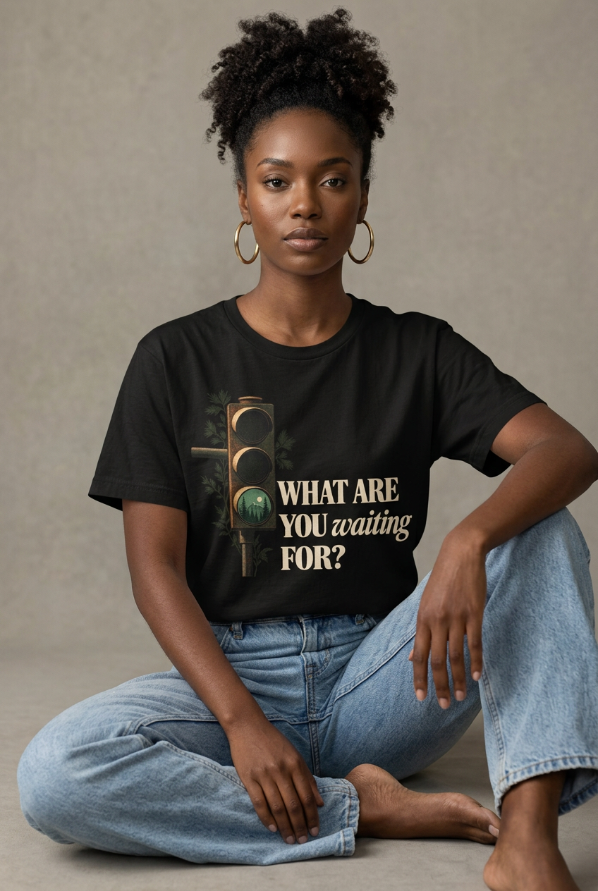 Woman wearing Black What Are You Waiting For? T-shirt seated in studio
