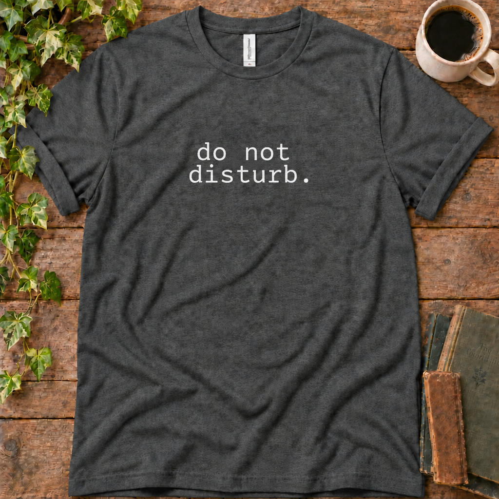 Dark grey heather regular-fit tee printed with do not disturb, flat lay on rustic wood with ivy, coffee and vintage books