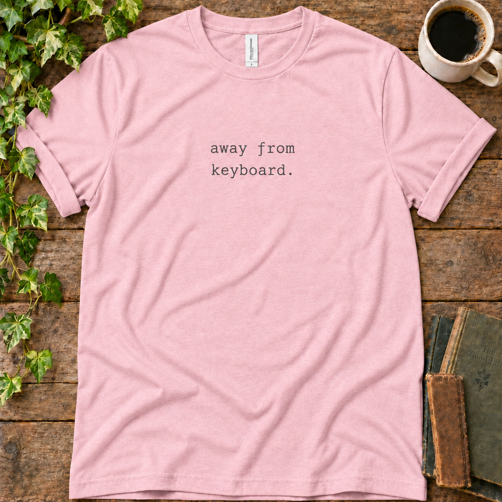 Pink regular-fit tee printed with away from keyboard, flat lay on rustic wood with ivy, coffee and vintage books