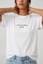 Woman wearing White sorry I'm offline mostly t-shirt, close-up editorial lifestyle