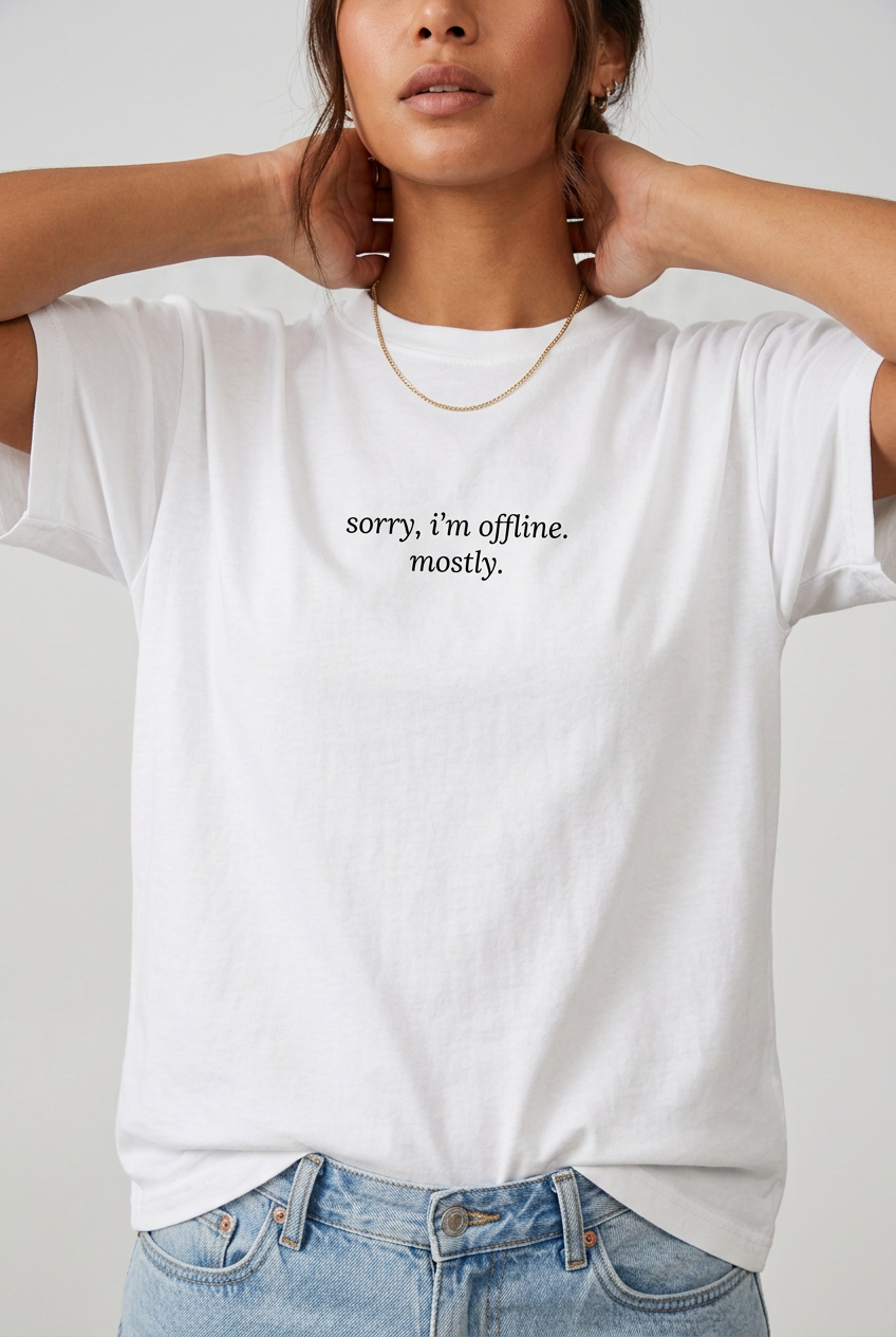 Woman wearing White sorry I'm offline mostly t-shirt, close-up editorial lifestyle