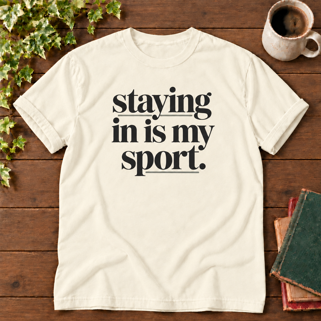 Staying in is my sport Ivory, folded sleeve flat lay with smooth timber, mug and books
