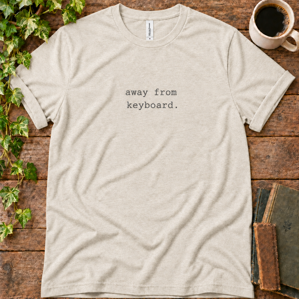 Natural oatmeal regular-fit tee printed with away from keyboard, flat lay on rustic wood with ivy, coffee and vintage books