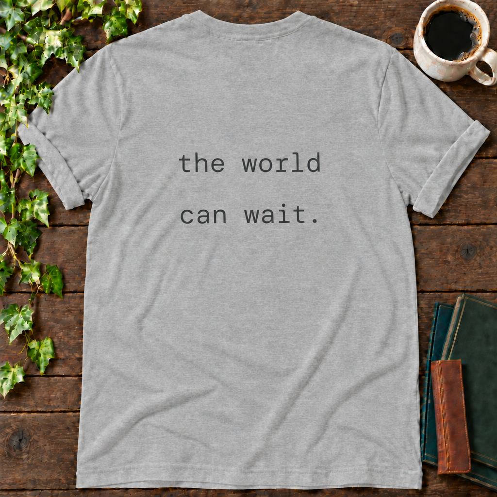 the world can wait. athletic heather t-shirt back print flat lay