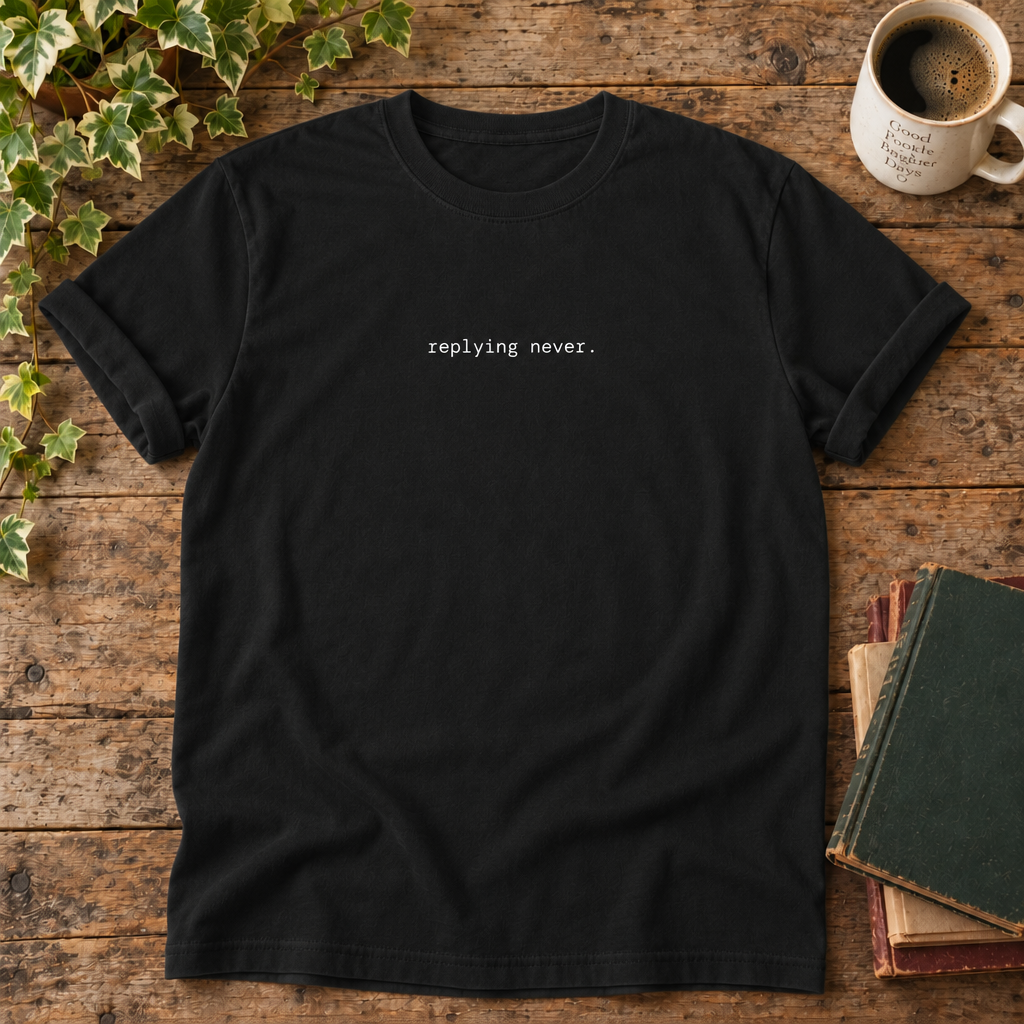 Replying never. Black t-shirt weathered-wood flat lay