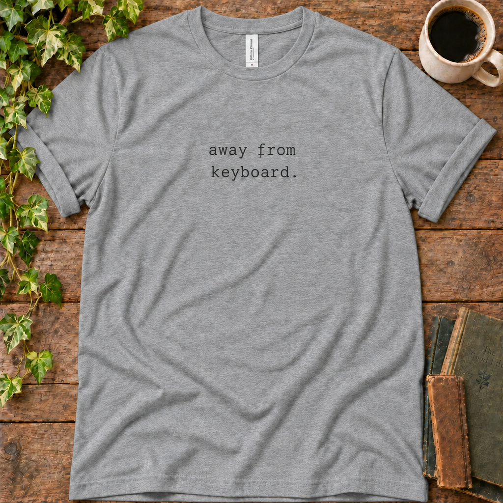 Athletic heather regular-fit tee printed with away from keyboard, flat lay on rustic wood with ivy, coffee and vintage books