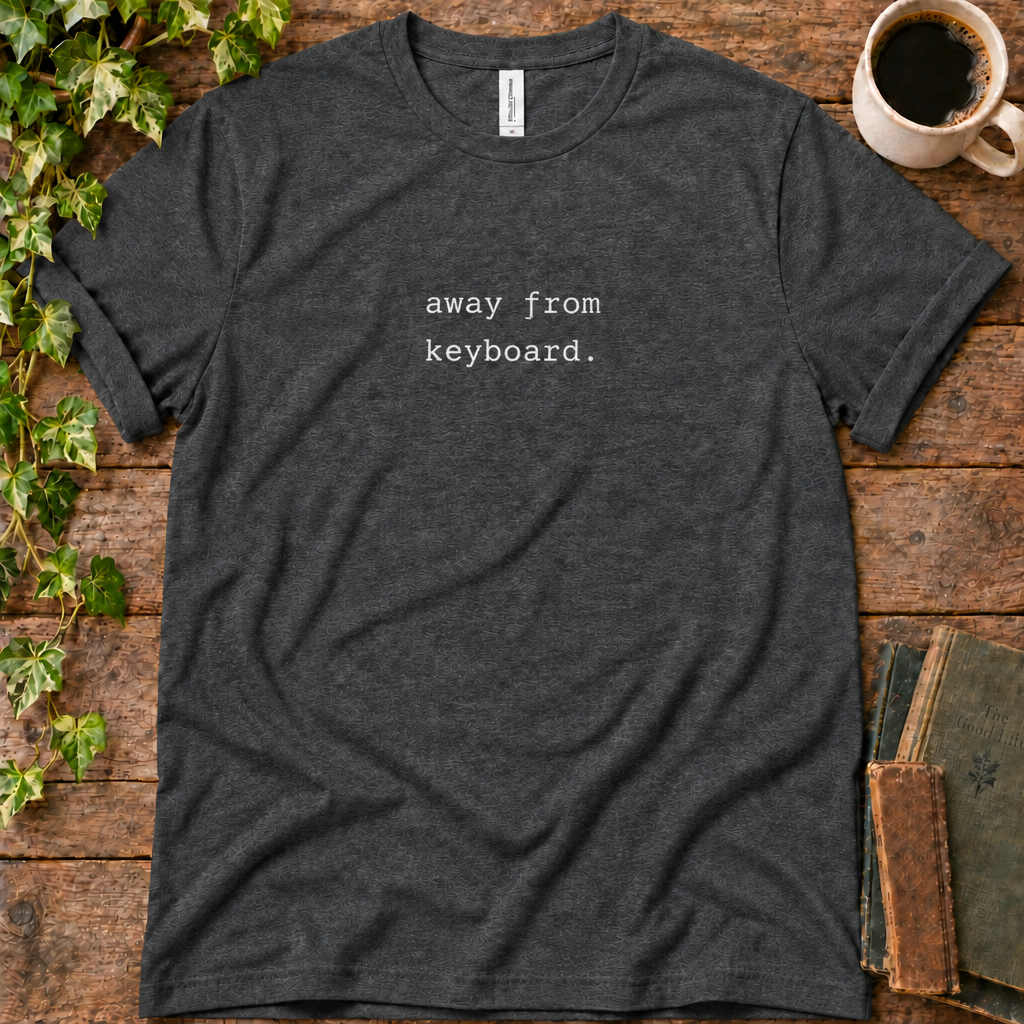 Dark grey heather regular-fit tee printed with away from keyboard, flat lay on rustic wood with ivy, coffee and vintage books