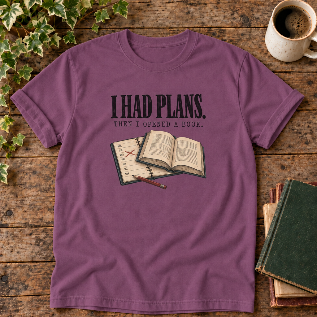 I had plans t-shirt in Berry, flat lay on dark rustic wood with ivy, coffee mug and green-over-red-and-tan book pile