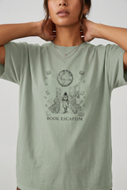Close-up model wearing book escapism reader t-shirt in Bay