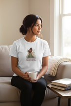 Person sitting on a sofa with a coffee mug wearing the Mentally Elsewhere T-shirt with a centred mid-chest print