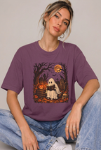 Model seated wearing the spooky ghost cemetery t-shirt in Berry