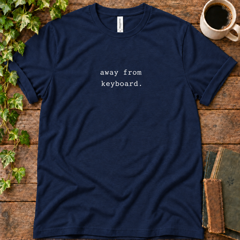 Navy regular-fit tee printed with away from keyboard, flat lay on rustic wood with ivy, coffee and vintage books