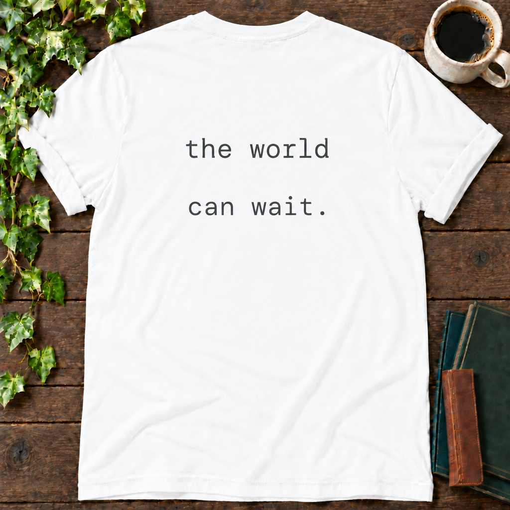 the world can wait. white t-shirt back print flat lay