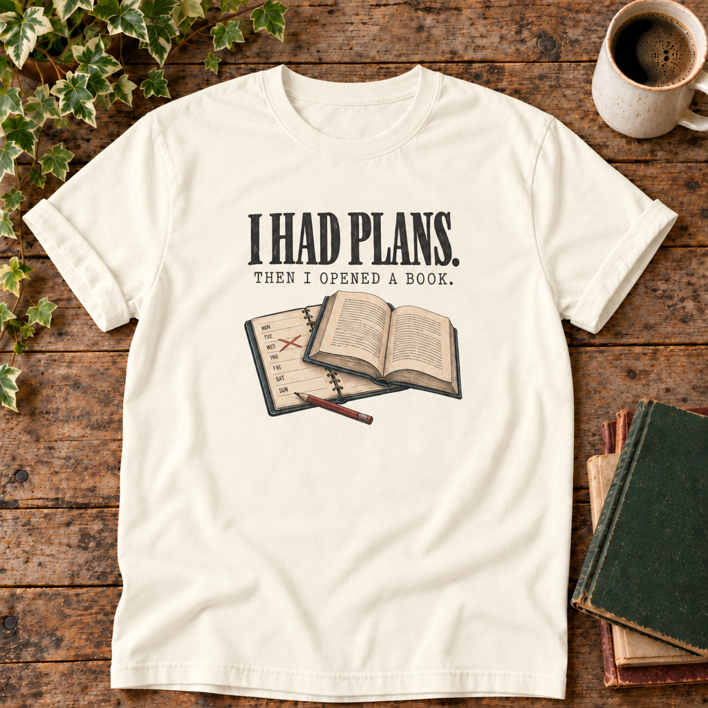 I had plans t-shirt in Ivory, flat lay on dark rustic wood with ivy, coffee mug and green-over-red-and-tan book pile