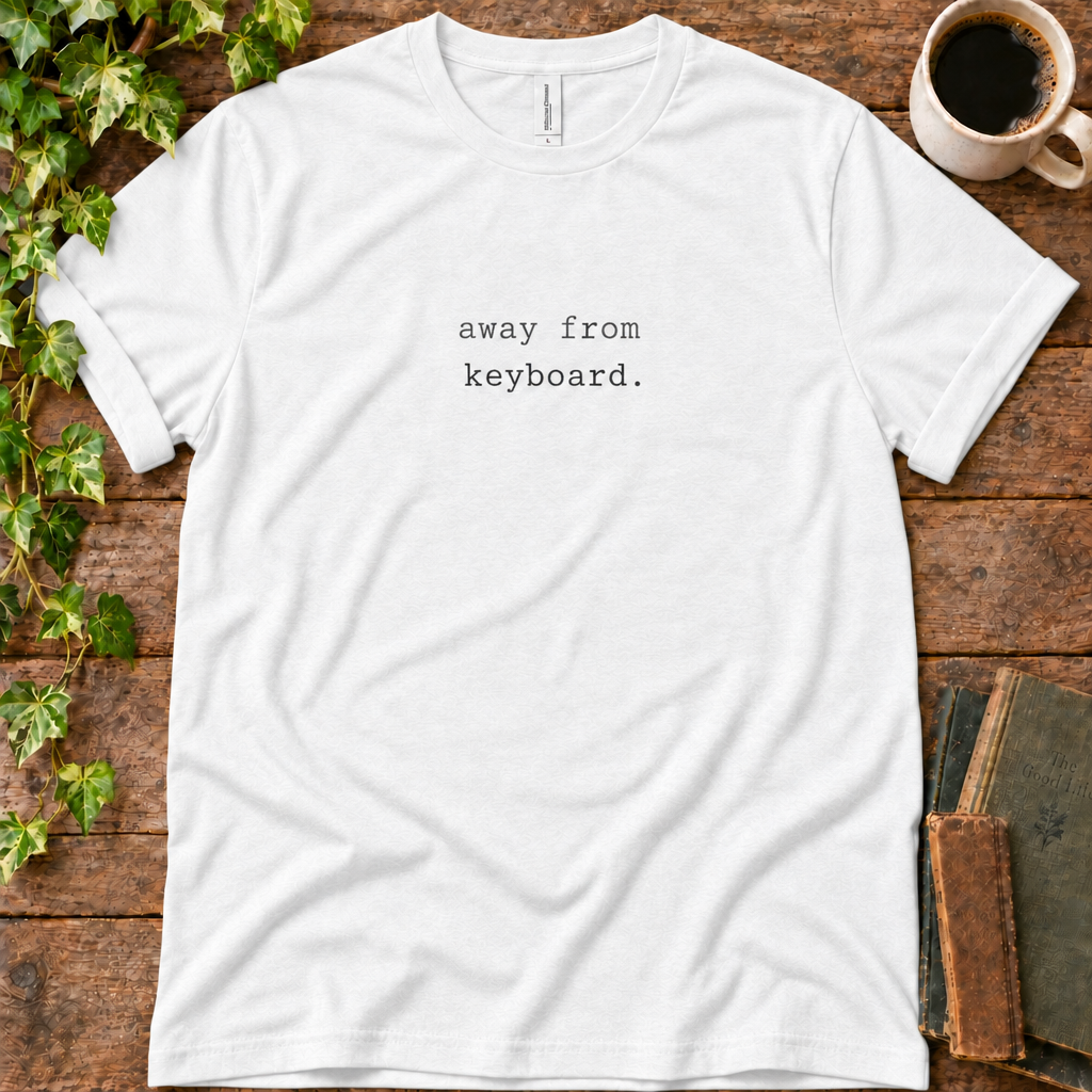 White regular-fit tee printed with away from keyboard, flat lay on rustic wood with ivy, coffee and vintage books