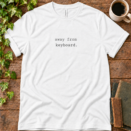 White regular-fit tee printed with away from keyboard, flat lay on rustic wood with ivy, coffee and vintage books