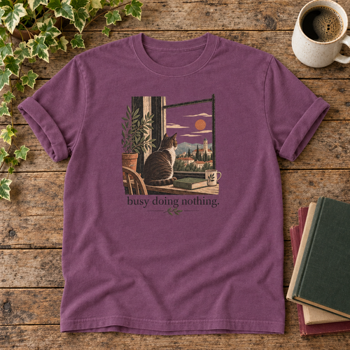 Busy doing nothing. Berry cat at window t-shirt flat lay