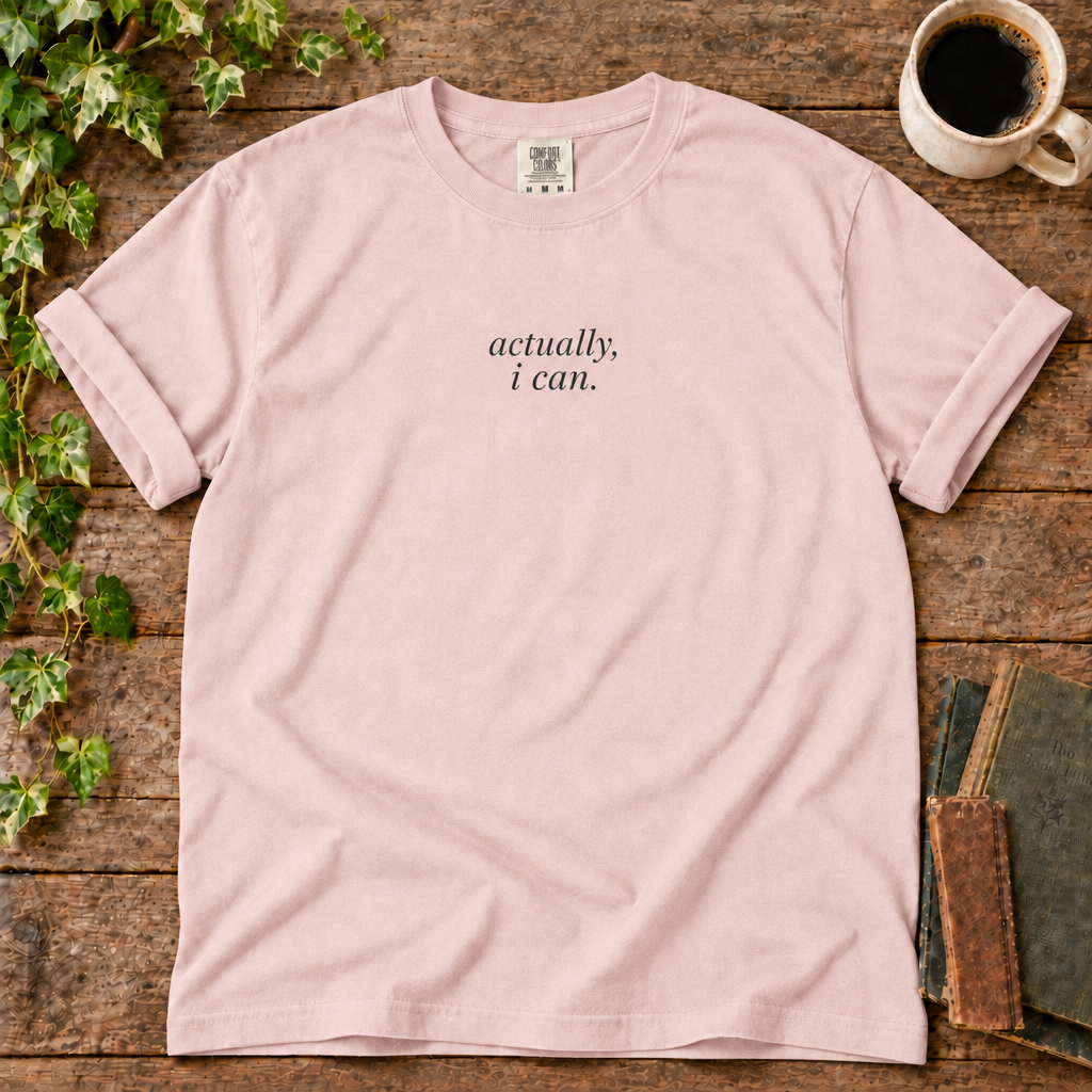 Blossom relaxed-fit tee printed with actually, i can., flat lay on rustic wood with ivy, coffee and vintage books