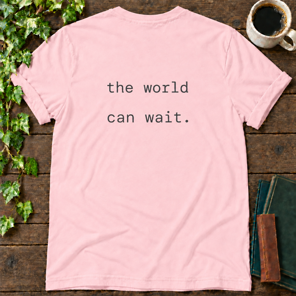 the world can wait. pink t-shirt back print flat lay