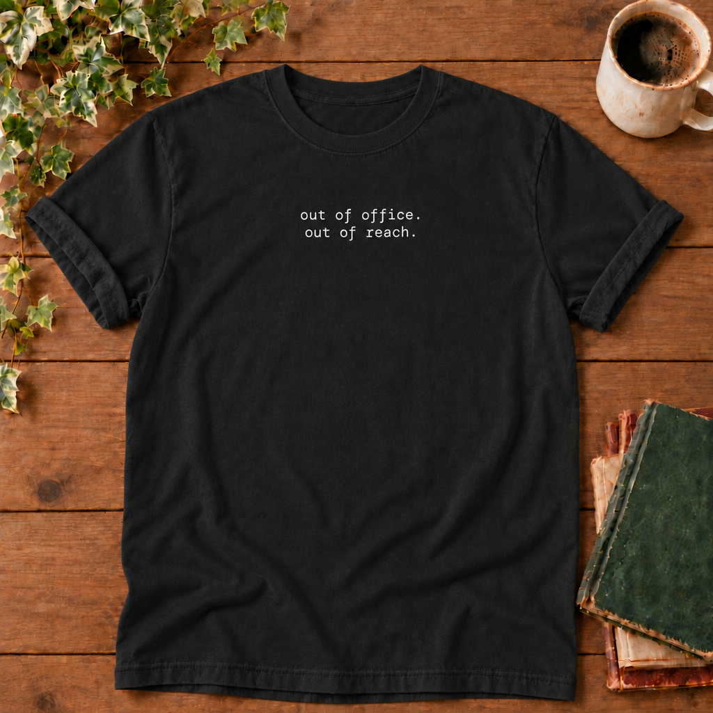 Out of office. Out of reach. Black t-shirt flat lay