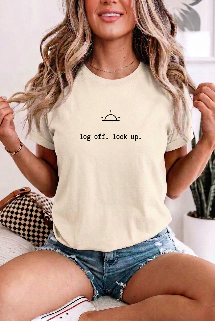 Woman wearing log off. look up. Ivory t-shirt