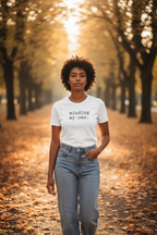 minding my own. — dark-skinned woman, white Bella Canvas, tree-lined path