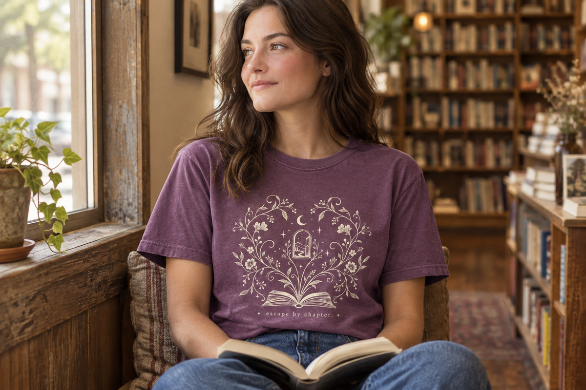 Woman wearing the Berry escape by chapter. t-shirt in a window-lit bookshop
