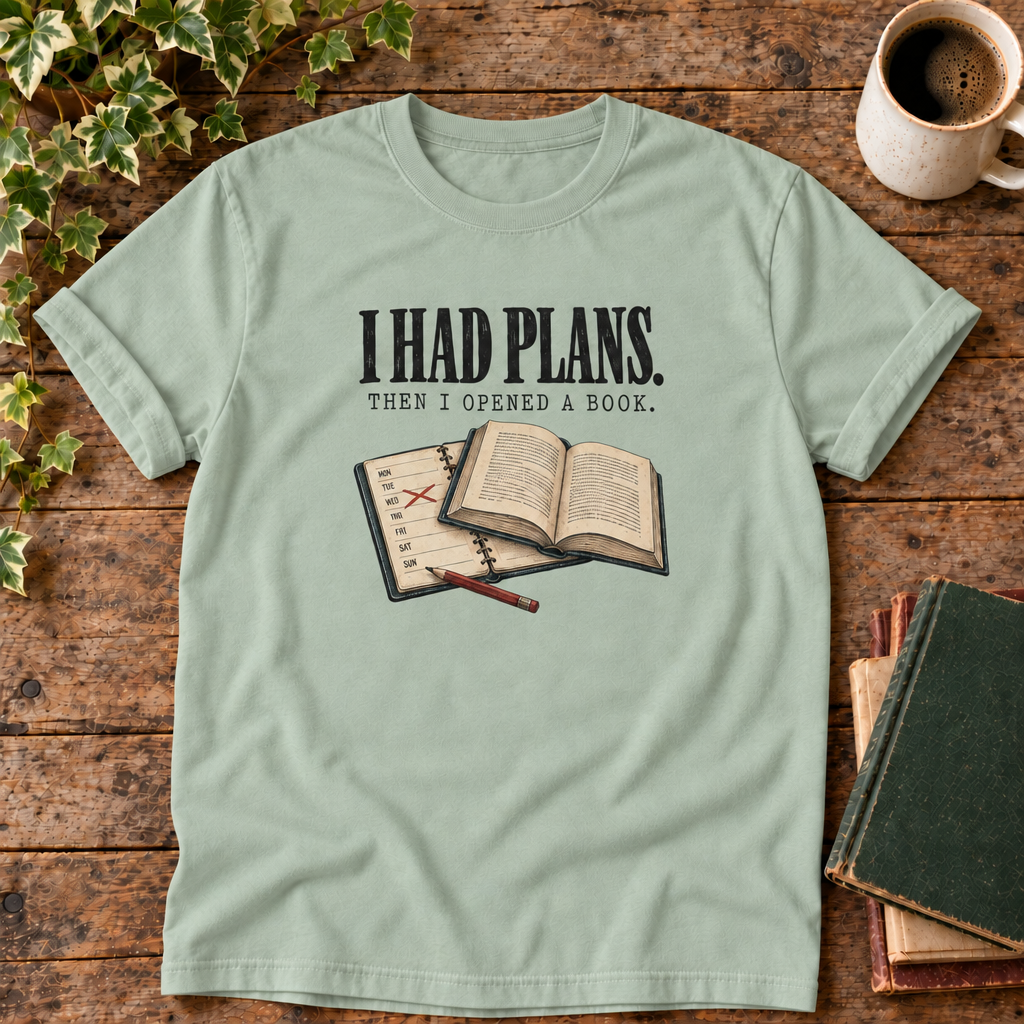 I had plans t-shirt in Bay, flat lay on dark rustic wood with ivy, coffee mug and green-over-red-and-tan book pile