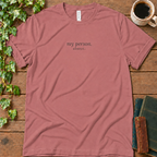 Mauve dusty rose regular-fit tee printed with my person. always., flat lay on rustic wood with ivy, coffee and vintage books