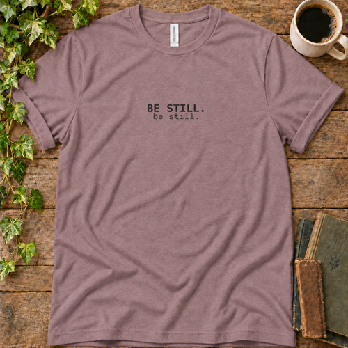 Mauve regular-fit tee printed with be still, flat lay on rustic wood with ivy, coffee and vintage books