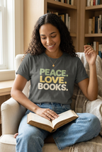 Woman wearing the Pepper peace love books t-shirt while reading in a cosy chair