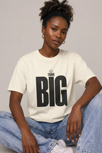 Woman wearing Ivory Think Big T-shirt seated studio lifestyle