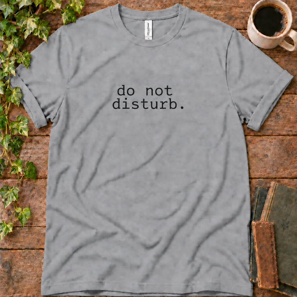 Athletic heather regular-fit tee printed with do not disturb, flat lay on rustic wood with ivy, coffee and vintage books