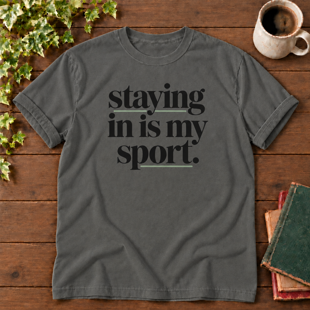 Staying in is my sport Pepper, folded sleeve flat lay with smooth timber, mug and books