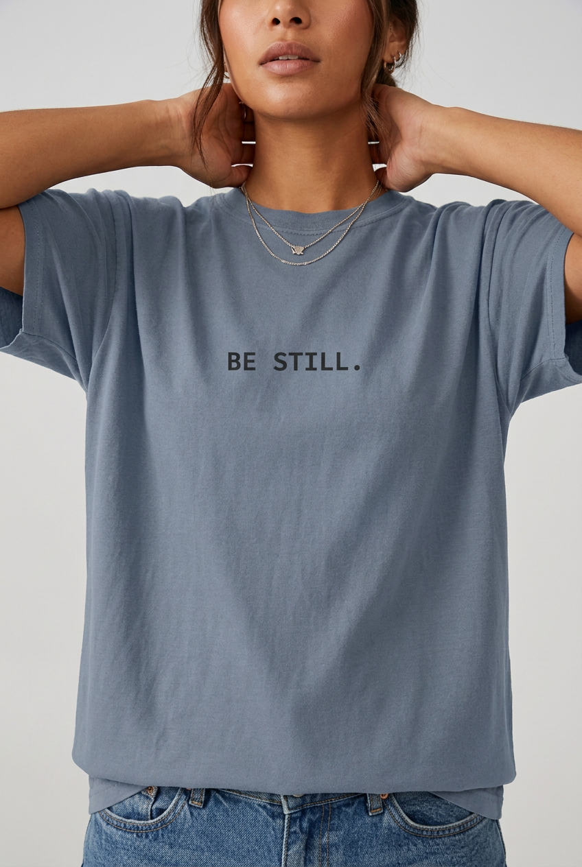 Woman wearing Blue Jean BE STILL. t-shirt, close-up editorial lifestyle