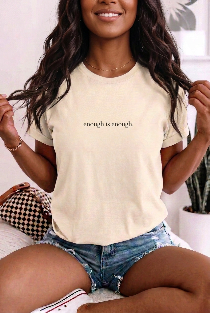 Brown-skinned woman wearing enough is enough. Ivory t-shirt