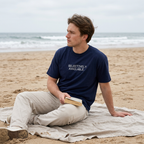 Selectively available, man on a beach blanket with a book